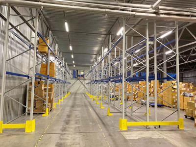 Workers assembling metal shelves in a warehouse